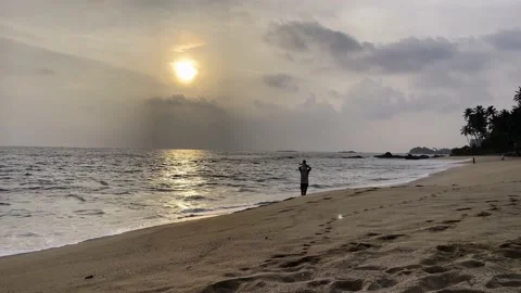 Father and son walking along the sea beach at sunset Stock Footage 219476310