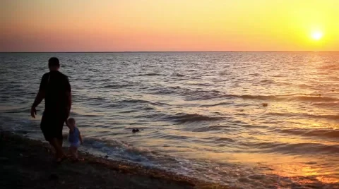 Father and son walking on the beach at sea And beautiful sunset. HD. 1920x1080 Stock Footage 47631276