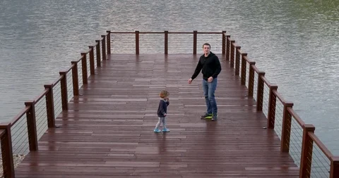 Father and son walking on bridge Video stock 107761150