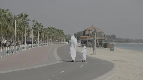 Father and son walking on the corniche. Stock Footage 302536340