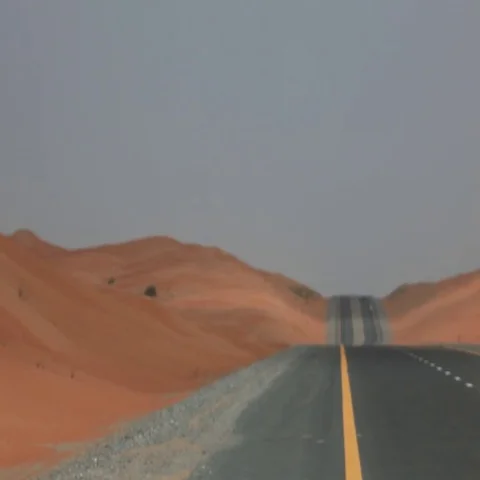 Father and son walking down the desert highway. Stock Footage 69488302