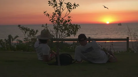 Father and Son Watching Sunset at Cable Beach, Broome, Western Australia Stock Footage 340887210
