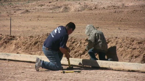 Father and Son Work on Forms for Home Foundation Stock Footage 455650