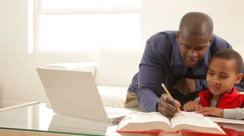 Father and son working on homework together Video stock 61673766
