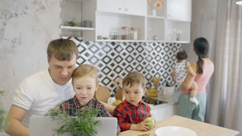 Father and two sons in multiethnic family sitting at the kitchen Stock Footage 92234137