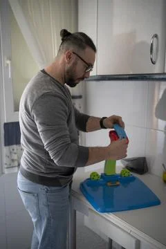 Father assembling toy to give it to his daughter Stock Photos