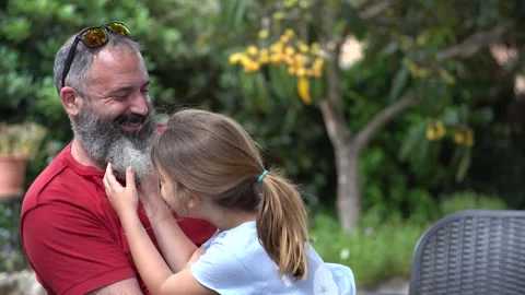 A father with a beard plays and laughs with his daughter Stock Footage 241255191