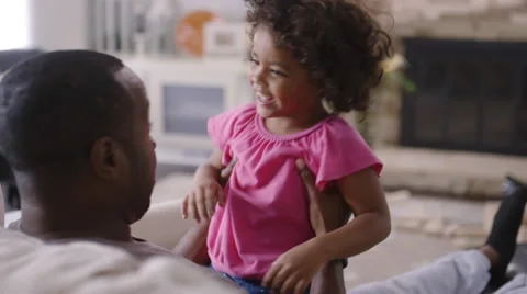 Father bouncing daughter on lap Stock Footage 61894569