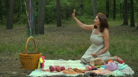 The father brings a little daughter in the bag on a picnic with family Stock Footage