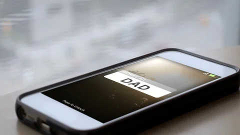 A Father calling a smartphone with the screen lighting up Video stock 78886591