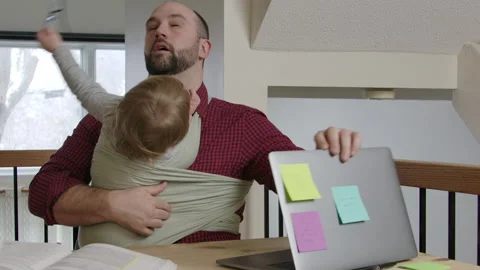 Father caring for children while working from home Stock Footage 145854057