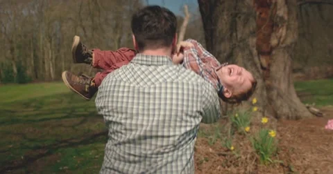 Father carry's son. Boy is consumed with laughter Stock Footage 60793916