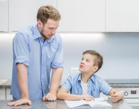 Father checking homework of son Stock Photos