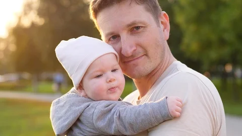 Father with child in park looking at camera. Happy family  Stock Footage 94487817