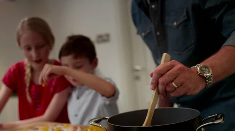 Father with children preparing pizza at kitchen. Stock Footage 64106872