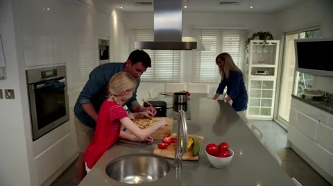 Father with children preparing pizza at kitchen. Stock Footage 64106966