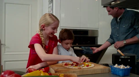 Father with children preparing pizza at kitchen. Stock Footage 64107153
