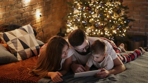 Father with children using a digital tablet on the bed Stock Footage 138938693