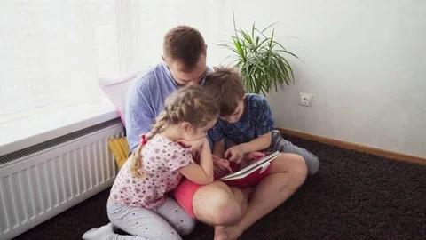 Father with children using a tablet Stock Footage 82422385