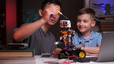 Father dad and son building a robot together at home Stock Footage 238678512