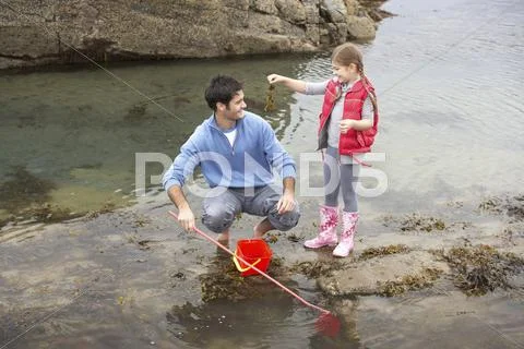 Father with daughter on beach Stock Photos