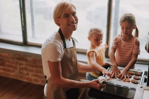 Father with daughters on kitchen Stock Photos