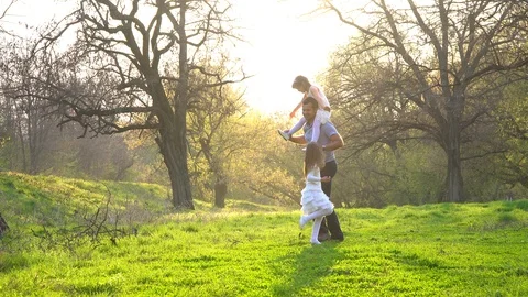 Father with daughters playing in the park Stock-Footage 108392996