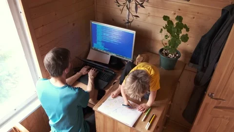 Father developer work from home on computer, small child sits near and paint Video stock 130495194