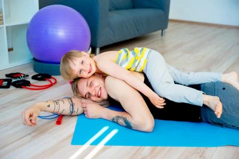 Father doing exercises with daughter Stock Photos