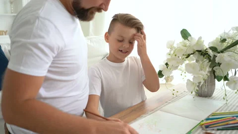 Father doing with son homework. They have fun together Stock Footage 115090714