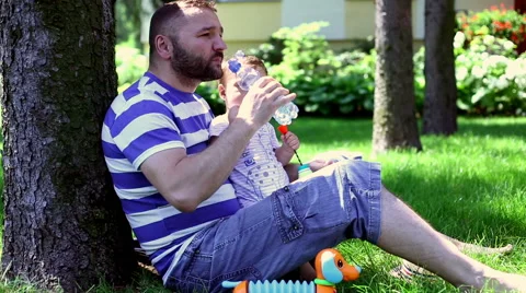 Father drinking water with son  Stock Footage 64945902