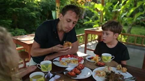Father eats with children at the table Stock Footage 244921267