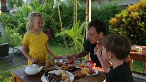 Father eats with children at the table Stock Footage 244921278