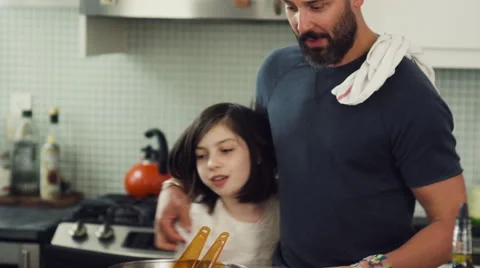 Father embracing his daughters in kitchen Stock Footage 63860423
