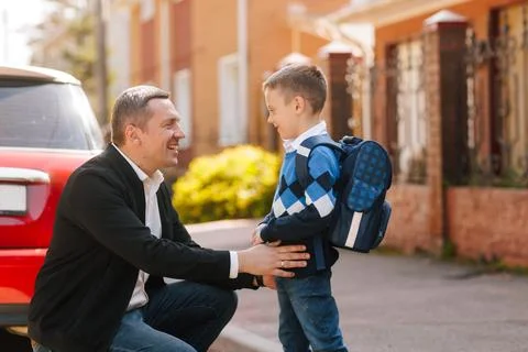 Father encourages son with backpack before first day of school, outdoor fam.. Stock Photos