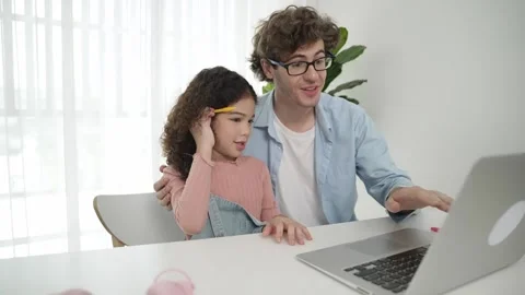 Father explain generate AI while american cute girl looking at screen. Pedagogy. Stock Footage 274121991