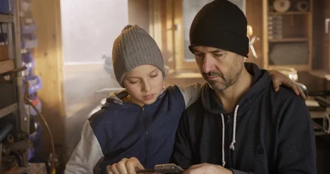 Father is explaining his son some craftsmen tools Video stock 85809000