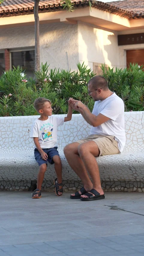 Father Explaining Something to His Young Son Outdoors Vídeos de archivo 342621365