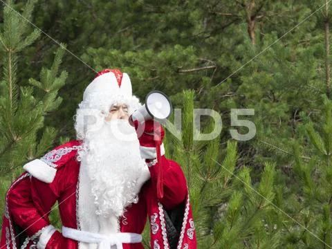 Father Frost shouts in the megaphone. Stock Photos