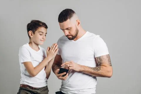 Father giving pocket money to happy son Stock Photos