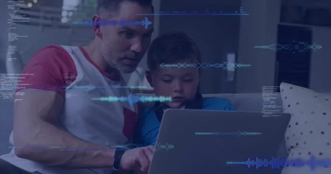 Father guiding son on couch, tapping laptop teaching coding, waveforms, code Stock Footage 331701152