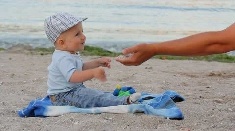 Father hand playing with the sand while baby is watching Stock Footage 12274608