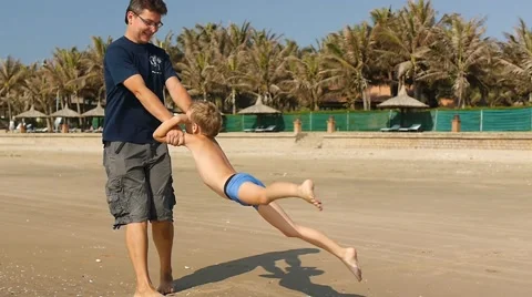 Father having fun playing with his happy son on the beach. Slow motion. Stock-Footage 50589402