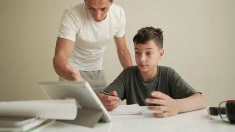 Father helping child do his homework at home. Homeschooling, distance learning Vídeos de archivo 194989724