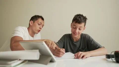 Father helping child do his homework at home. Homeschooling, distance learning Stock Footage 194989779