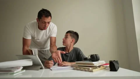 Father helping his son with schoolwork. Video stock 196828536