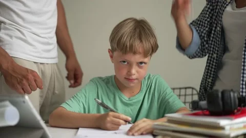 Father helping his son with schoolwork. Young little shoolboy solving Stock-Footage 196980495