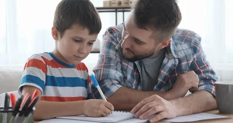 Father helping son to do school homework 動画素材 109374528