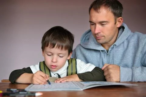 Father helping son doing homework Foto stock