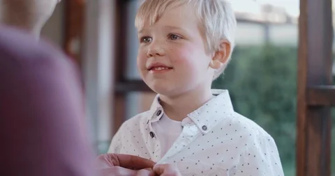 Father helping son get dressed in smart shirt Stock Footage 120350693